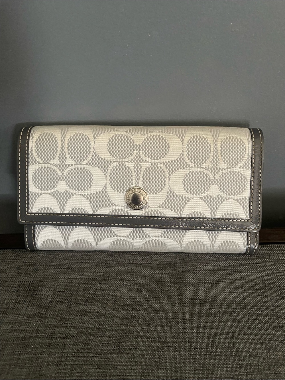 Coach Signature Canvas Trifold Wallet in Light and charcoal Gray.